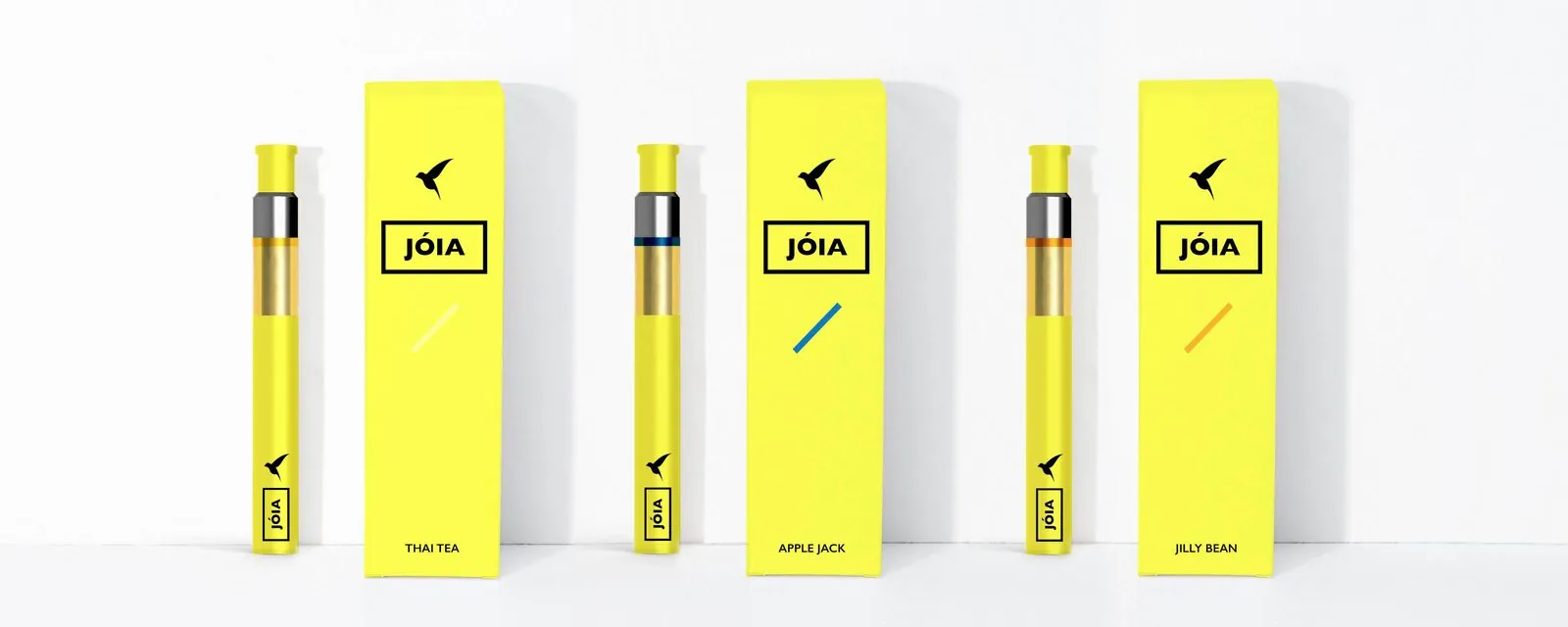 Three yellow Jóia vape pens with boxes: Thai Tea, Apple Jack and Jilly Bean